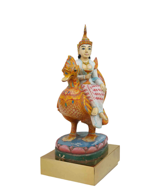 Wooden Saraswati Statue With Vibrant Colors Sitting On A Hamsa Bird